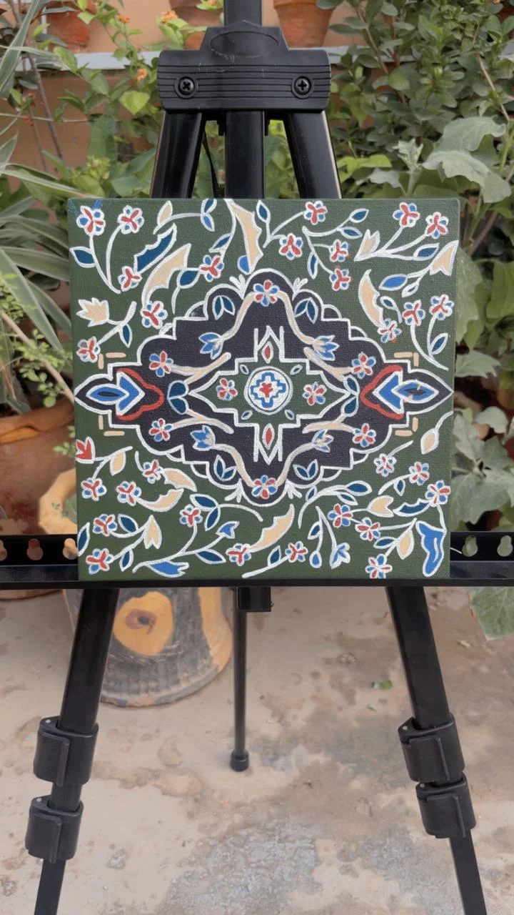 A hand-painted floral artwork in olive, cream, blue and rose