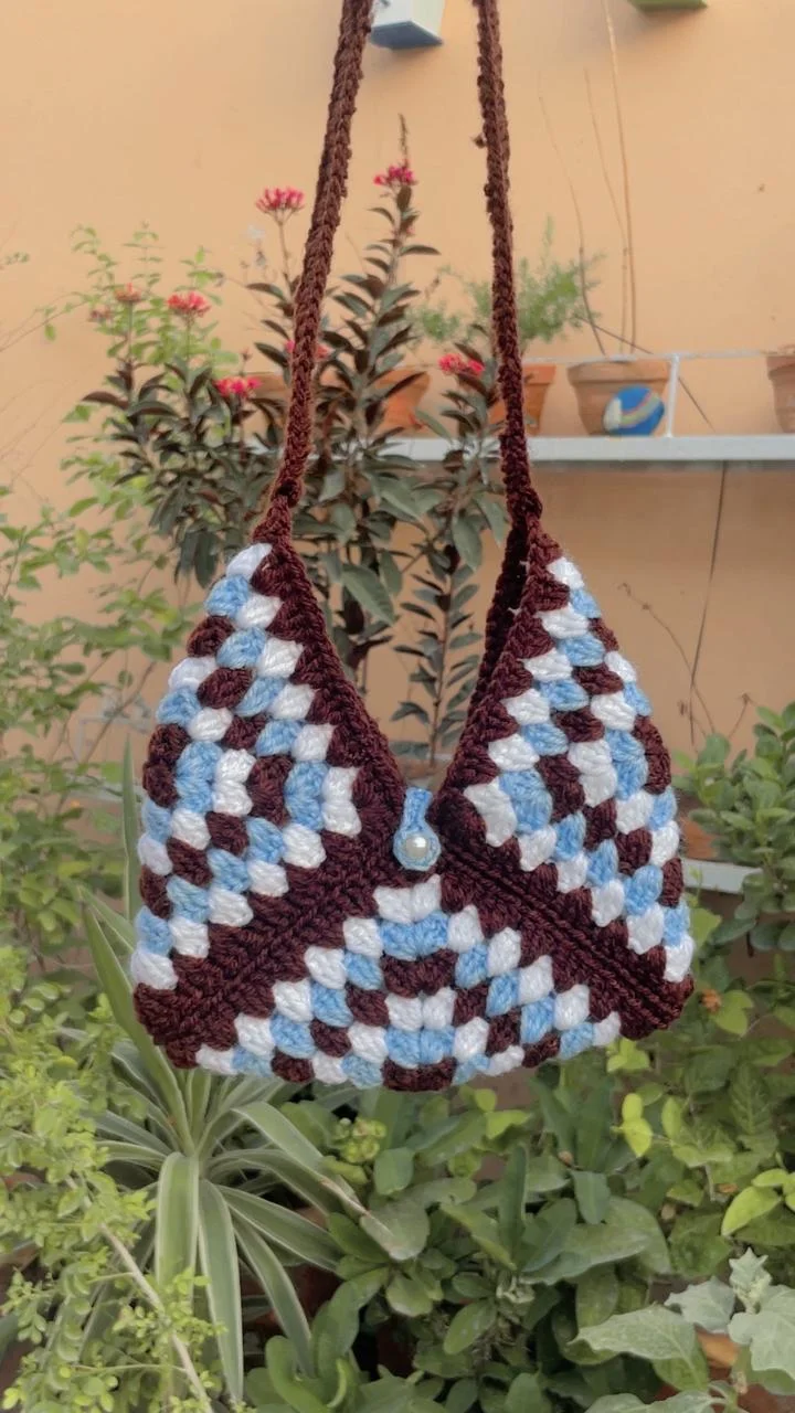 A cocoa and sky-blue crochet bag, handmade by Lamees